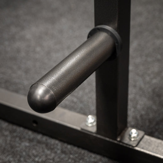 A weight lifting rack presented in a home gym setting, showcasing attachment points for weight plates