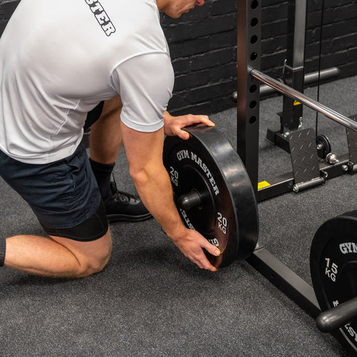 A weight lifting rack presented in a home gym setting, showcasing attachment points for weight plates