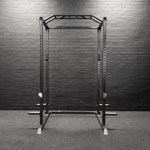 A weight lifting rack presented in a home gym setting