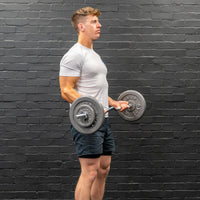 Thumbnail for Man performing bicep curl with ez-bar barbell and gunmetal GYM MASTER weight plates