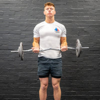 Thumbnail for Man performing bicep curl with ez-bar barbell and gunmetal GYM MASTER weight plates