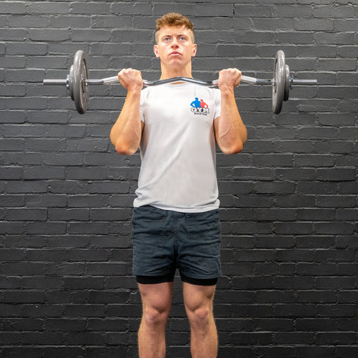 Man performing bicep curl with ez-bar barbell and gunmetal GYM MASTER weight plates